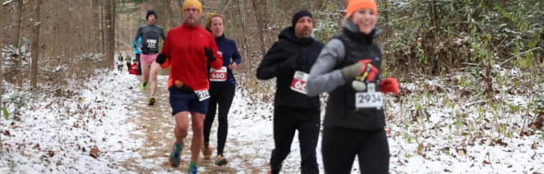 Black Toenail Friday trail Half Marathon and 7.5 Mile race runners on snowy trails at Proud Lake State Rec Area in Commerce Township, MI